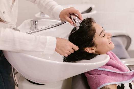 pexels-photo-7755663-7755663 A young woman enjoys a relaxing hair wash at a modern beauty salon.